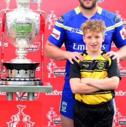 Warrington captain Chris Hill, one of several Wiganers in the Wolves squad, with Orrell St Peter's Year 7 captain Ryan Wood, who will play in the curtain-raiser