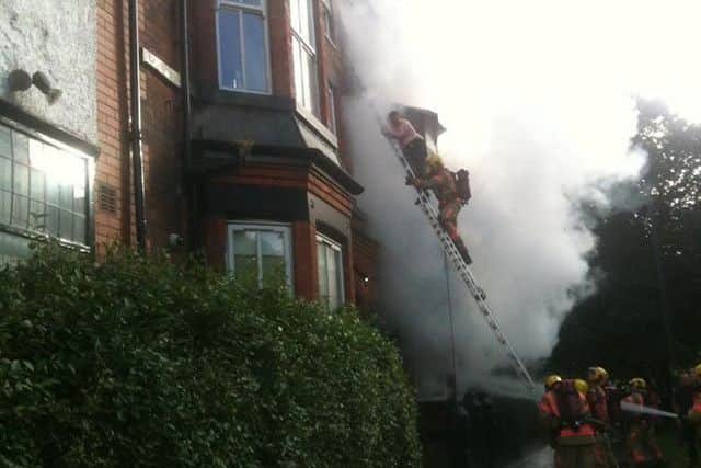 Firemen rescue people from the burning building. Picture by Paul McCormick