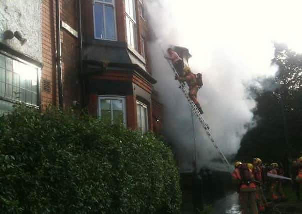 Firemen rescue people from the burning building. Picture by Paul McCormick