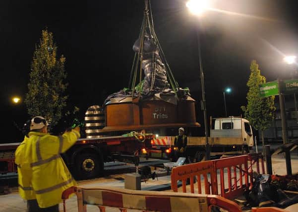 The statue is lowered into place