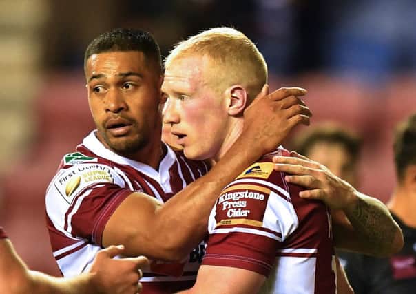 Liam Farrell is congratulated by Willie Isa after scoring Wigan's only try