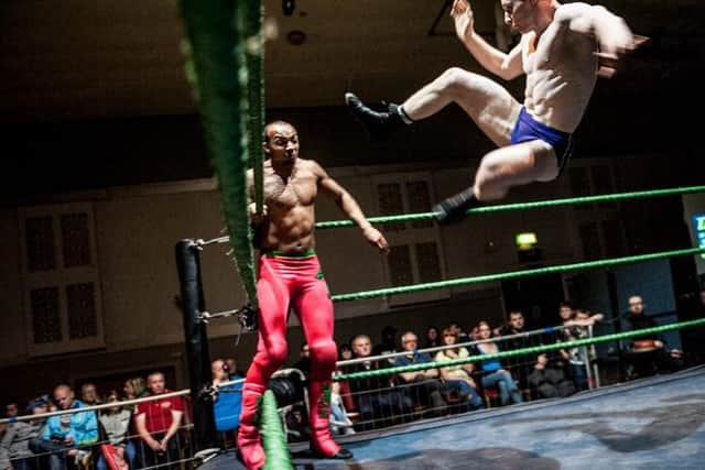 Wrestler Jack Gallagher (right) battling Ashton Smith at a Grand Pro Wrestling show in Hindley
