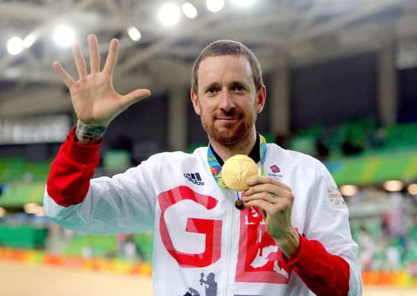 Sir Bradley Wiggins celebrates with his gold medal on Rio following victory in the men's team pursuit final, his fifth Olympic Gold