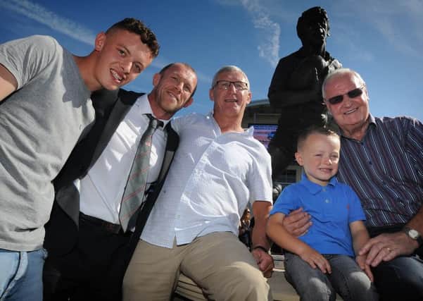 A statue of Leigh rugby league legend John Woods was officially unveiled. 
John (white shirt) with L-R: grandson Luke Briggs-Wood, present Leigh Centurions captain Mickey Higham, grandson Rieve Woods and former Leigh coach Alex Murphy