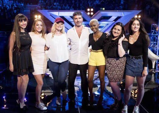 Olivia Garcia, second left, with fellow X Factor contestants and Simon Cowell at the end of the X Factor Six Chair Challenge phase