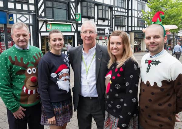 Coun David Molyneux (centre) and council staff at the site of the festive markets