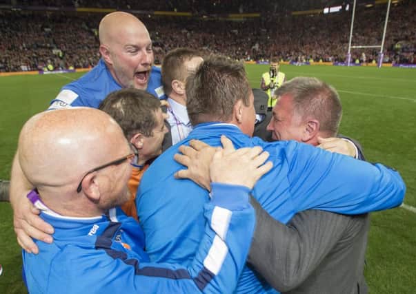 The coaching staff hug Shaun Wane after the full-time whistle