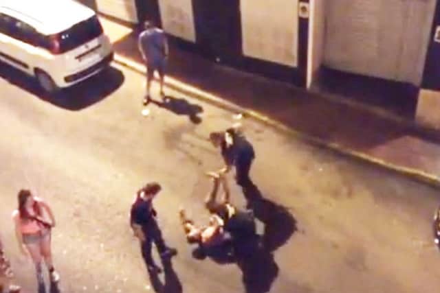 Luke (on the floor) and two police officers shortly after his balcony fall