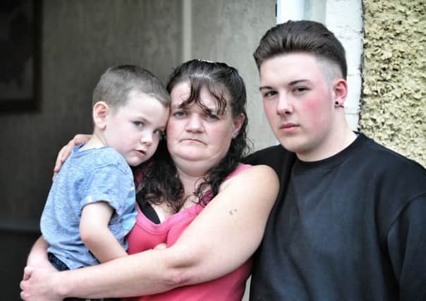 Catherine Carter who is a victim of scandal-hit tax credit firm Concentrix pictured at her Abram, Wigan, home with sons Daniel (4) and Callum (17)