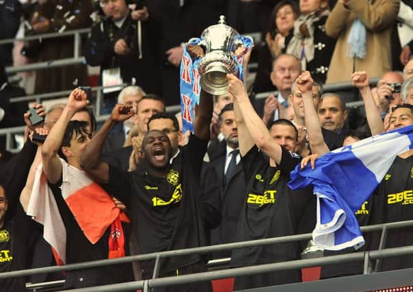 Gary Caldwell and Emmerson Boyce lift the FA Cup