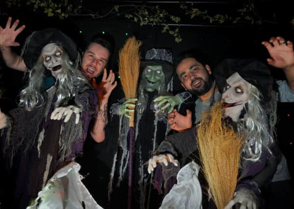 Pub landlords Chris Tolley, left, and Jean Cubas, right, join scary creatures, ghosts and ghouls as they await visitors to the Halloween events at The Wellfield Hotel