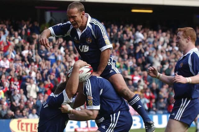 Adrian Lam leads the celebrations with Gary Connolly and Kris Radlinski during the 2002 Challenge Cup Final