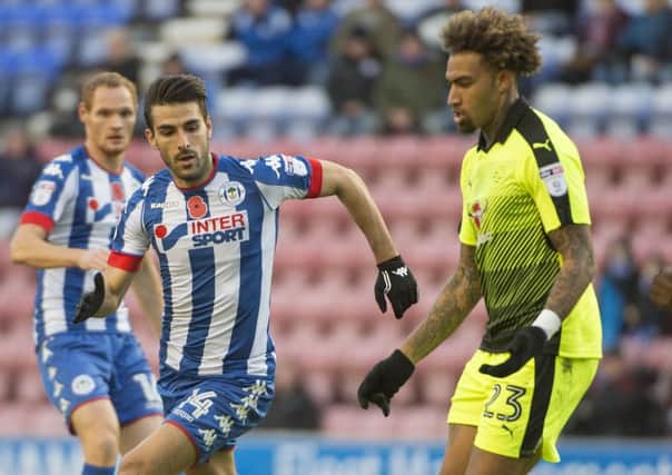 Jordi Gomez closes down Garath McCleary, who scored two goals in Readings 3-0 win over Latics at the weekend