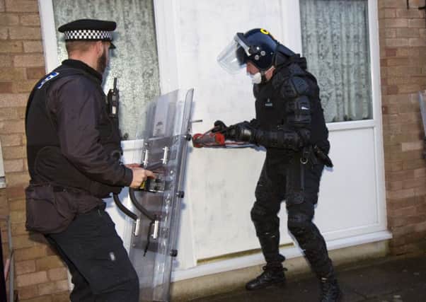 Police raiding an address in Thatto Heath