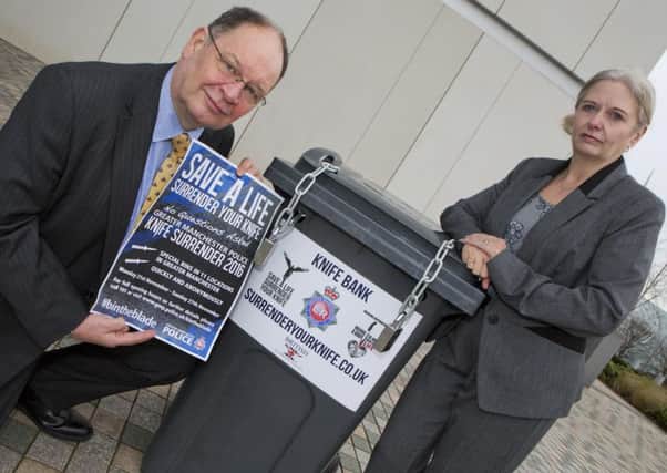 Deputy Police and Crime Commissioner Jim Battle and Det Chief Inspector Debbie Dooley with one of the bins used