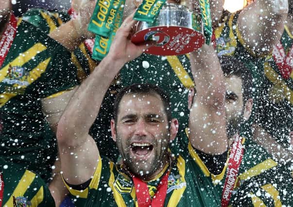 Australia's Cameron Smith lifts the Four Nations trophy. The Kangaroos are also World Champions