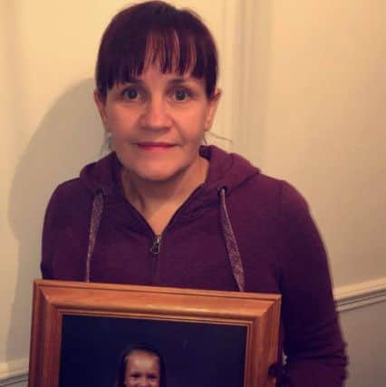 Amanda Goodison with a photograph of her daughter Rebecca