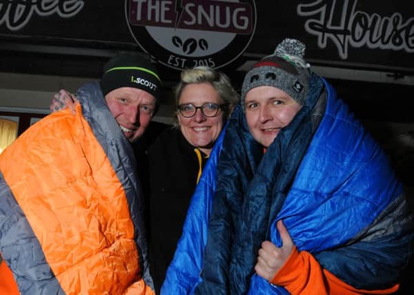 Rachael Flaszczak, owner of The Snug cafe, Atherton, with John Worrall, left, and David Simpson, right, who are preparing to spend the night sleeping on the streets