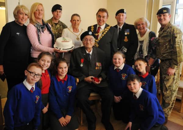 British World War Two veteran Bernard Sharrock, 92, is awarded with the Legion d'Honneur, presented by the Mayor of Wigan coun Ron Conway, surrounded by family, friends, members of the armed forces and pupils from Worsley Mesnes Community Primary School