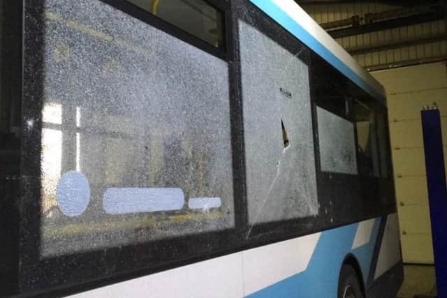 Damage to the windows of a Jim Stones Coaches bus after yobs hurled stones at it