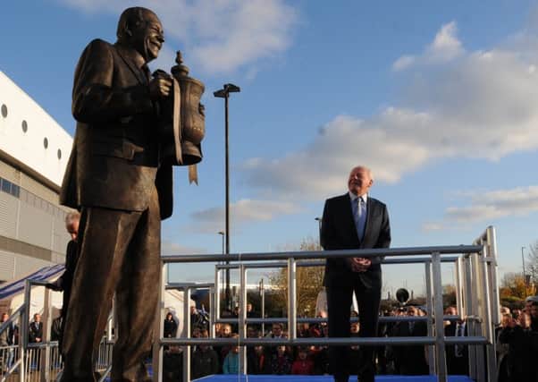 Dave Whelan with his statue outside the DW Stadium