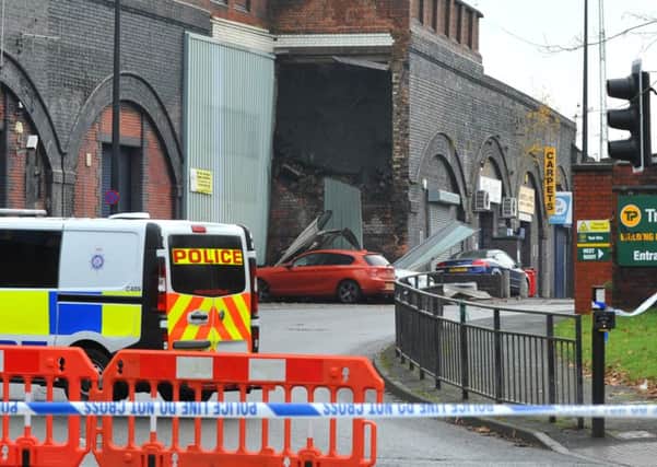 Police at the scene of a landslide at Wigan North Western train station, as a wall of a disused subway collapsed.