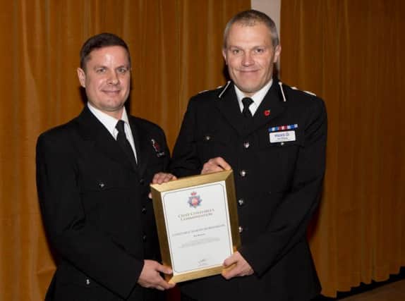 PC Martin Burkinshaw (left) receives his award from Deputy Chief Constable Ian Pilling