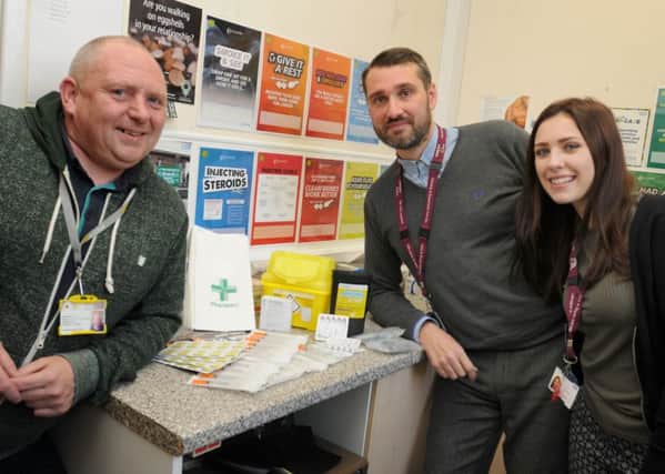 Community engagement co-ordinator Wayne McGarrigan, team manager of Greater Manchester West Trust Aron Moss and health care worker Helen Sharples in the needle exchange, at the Coops Building, Wigan