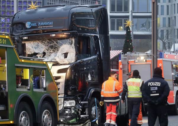 The smashed window of the cabin of a truck which ran into a crowded Christmas market Monday evening killing several people Monday evening in Berlin