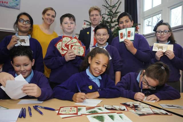 Some of the pupils from Mabs Cross Primary School who helped write Christmas cards to go with the donated presents