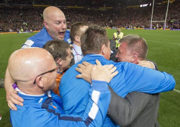 Shaun Wane celebrates Grand Final victory with his staff, including the departed Mick Farrell (bottom left)