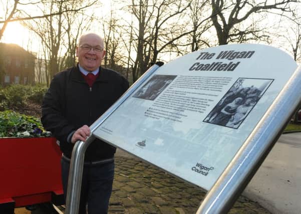 Coun George Davies with a pit tub, celebrating mining history in Wigan, on display in Mesnes Park, Wigan