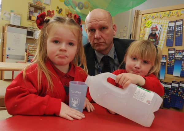 Headteacher David Worthington, centre, with pupils from nursery at Worsley Mesnes Primary School, Wigan, they are upset after the milk delivery was stolen from the school in the early hours of the morning.