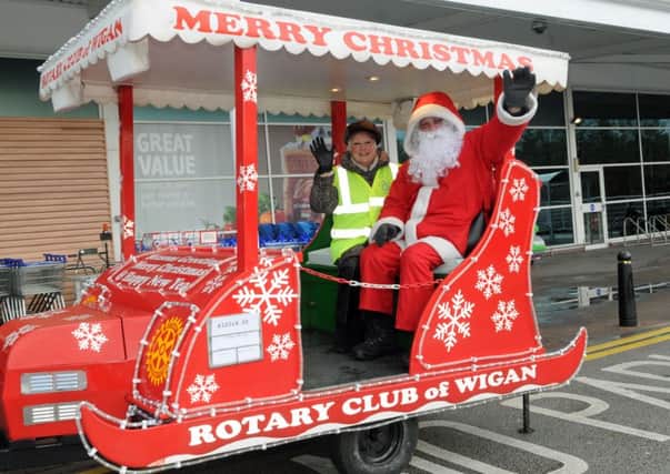 Lesley Hargraves with Santa at Wigan Rotary's Christmas float outside Tesco Supermarket in Wigan