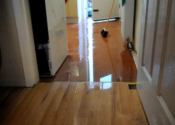 Water damage in a resident's home on  Pool Street