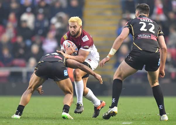 Romain Navarrete takes the ball in during his first Wigan Warriors appearance