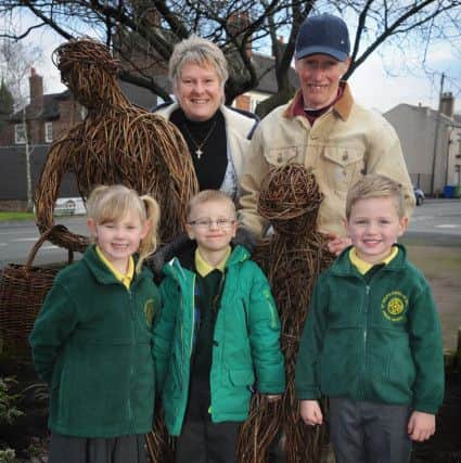 Pupils Sophia Seddon, William Maher and Jack Smith with the statue, plus Tina Farow and AEPs Keith Sumner