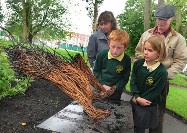 Coun Karen Aldred, Keith Sumner and school pupils with the burned statue