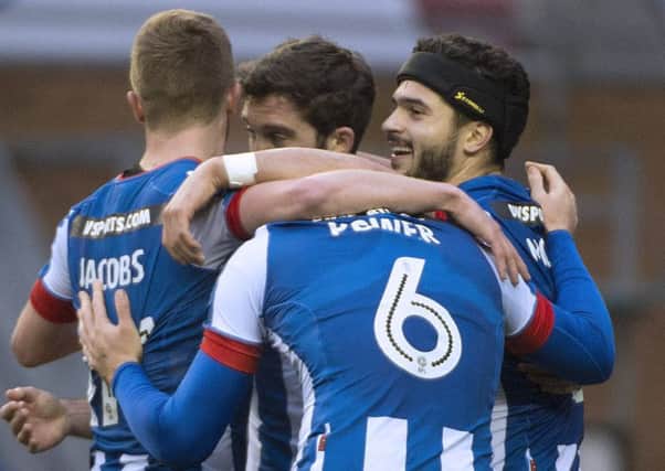 Wigan Athletic players celebrate a goal against Brentford
