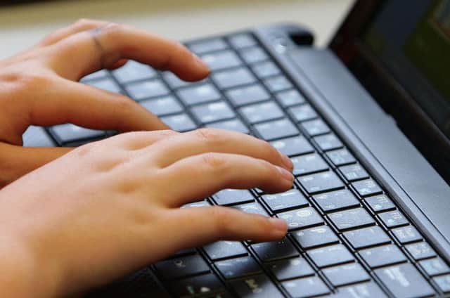 File photo of a young person using a laptop. Dave Thompson/PA Wire