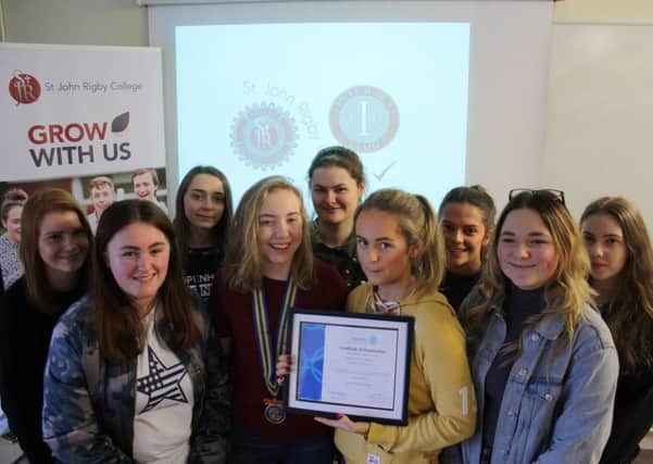 Club president Mia Cliffe, vice-president Chelsy Boyne-Nelson, secretary Melissa Molyneux and treasurer Emily Warburton with the other club members at the handover of the clubs official registration certificate from Rotary International