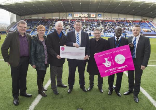 Wigan Athletic Community Trust receiving a cheque for more than Â£400,000 from the Big Lottery Fund for its Pathway 2 Participation scheme
