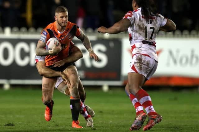Castleford Tigers' Zak Hardaker tries to break free from the Leigh Centurions' defence