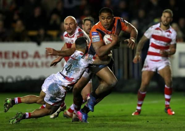 Castleford Tigers' Junior Moors(right) is tackled by Leigh Centurions' Eloi Pelissier