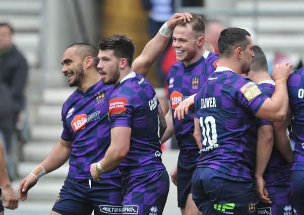 Wigan players celebrate their win over Salford on Saturday