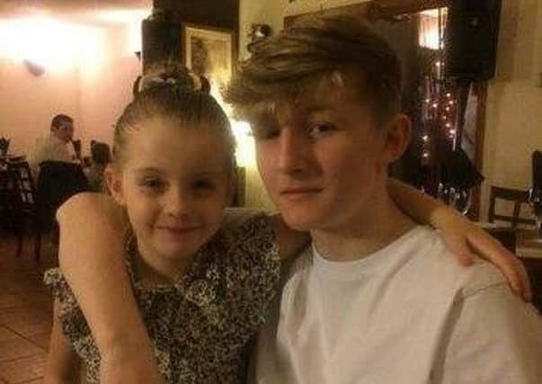 Cameron celebrating his 15th birthday with his six-year-old sister Brodie