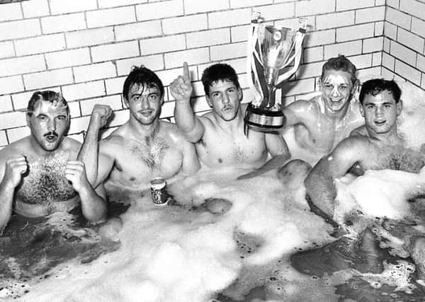 Wigan players Brian Case, Joe Lydon, Richard Russell, Steve Hampson and Andy Goodway in the bath with the trophy after beating Manly - picture Frank Orrell