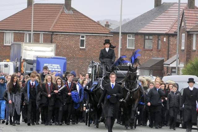 The procession included a horse-drawn carriage taking Cameron on his final journey