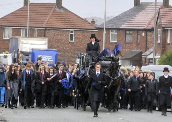 The procession included a horse-drawn carriage taking Cameron on his final journey