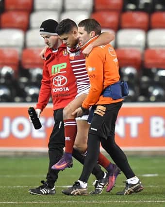 Jake Shorrocks is helped off the pitch